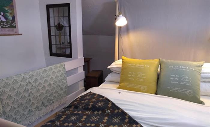 The cozy mezzanine double bedroom in Farmhand.